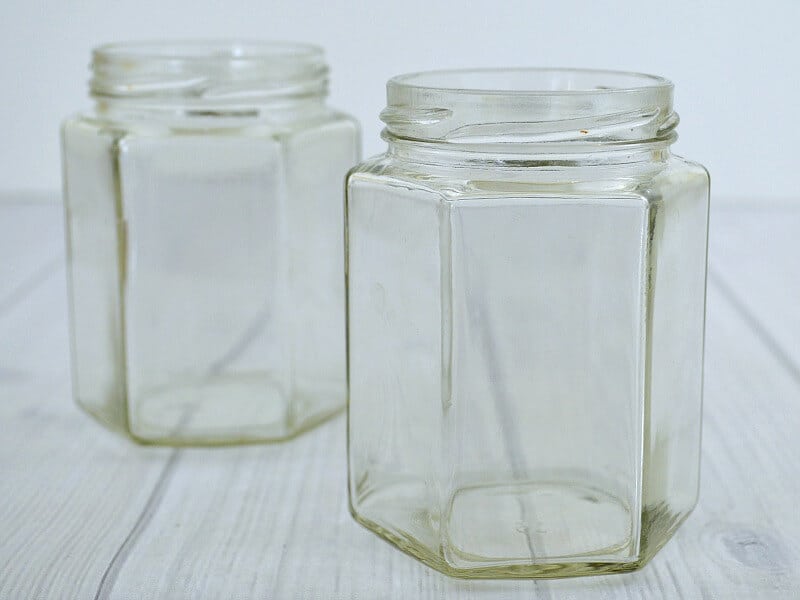 2 clean clear jars on white wood table