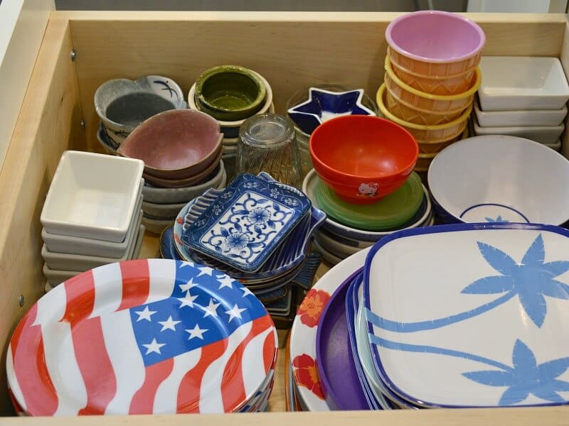 sideview of plates and bowls in open deep drawer