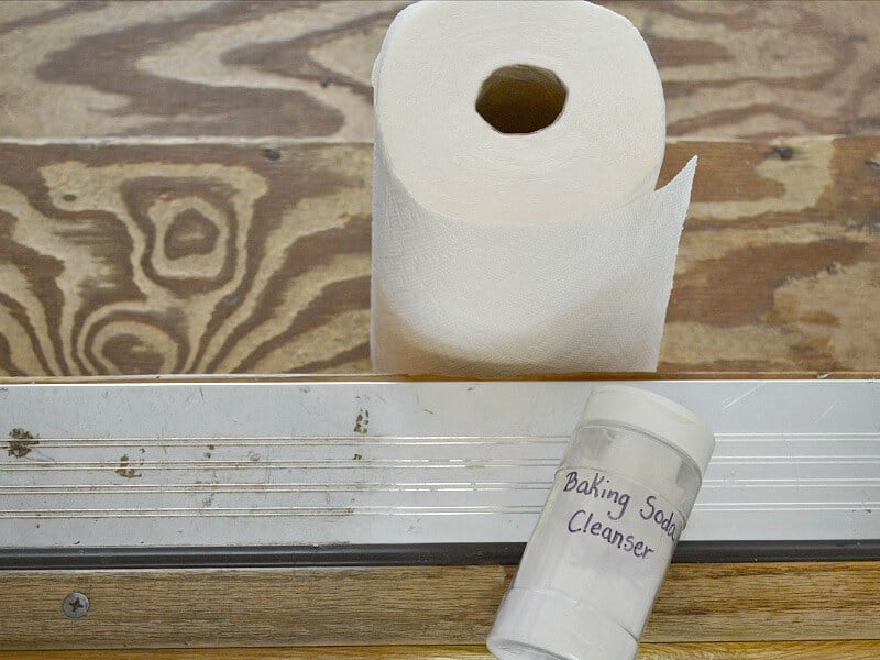 roll of paper towels, container of baking soda and door track