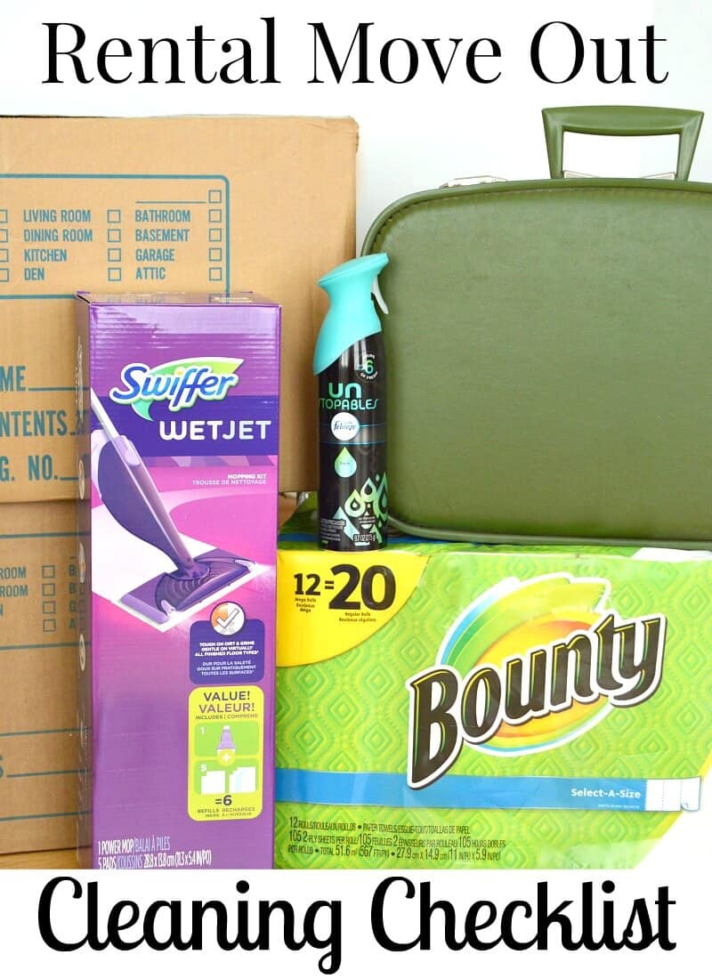 suitcase on top of package of paper towels,, box  with floor mop and stacked moving boxes