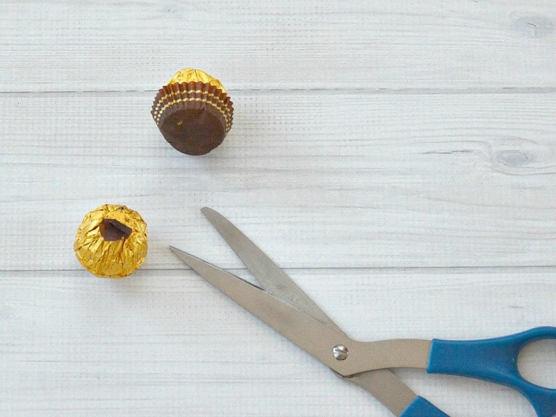 blue scissors and 2 pieces of gold foil wrapped candy