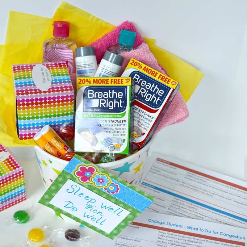 overhead view of gift basket with cold remedy items and checklist on white table