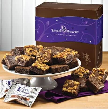 cake stand with brownies in front of a large brown gift box 