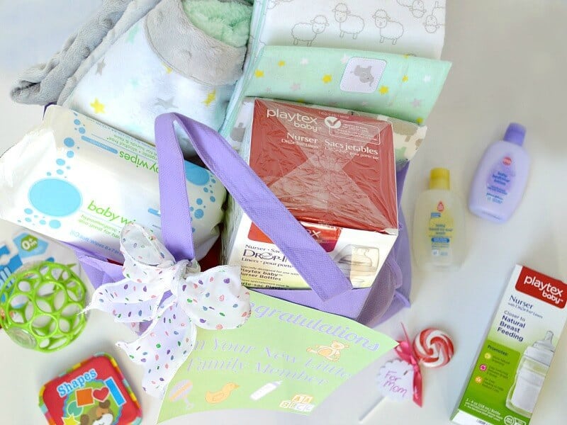 overhead view  of baby gift bag items on white table