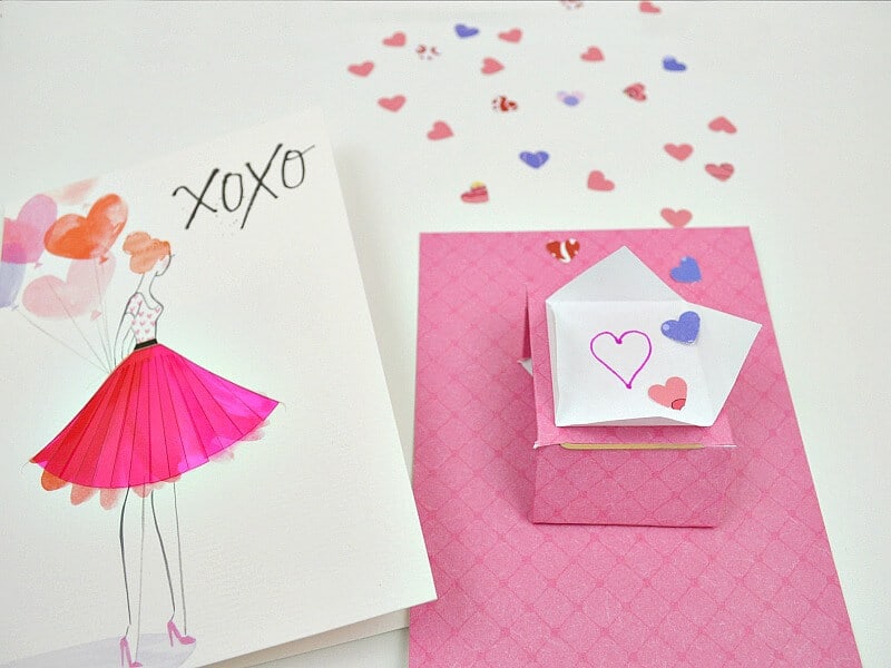 Valentine's card with woman in pink skirt next to pink confetti flinger card insert