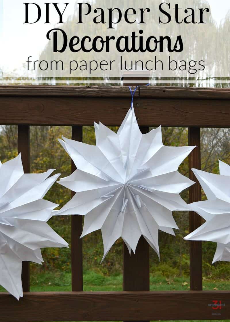 3 large DIY paper star decorations on deck railing 