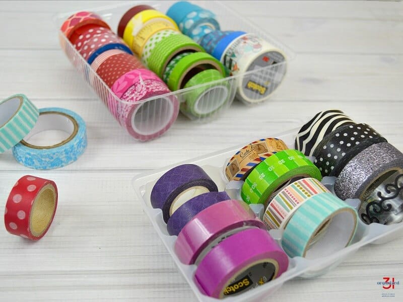 2 trays of neatly organized colorful washi tape on white wood table