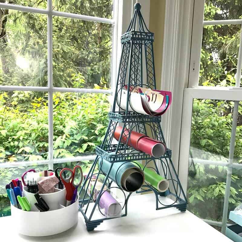 desk by window with utensil caddy and tower organizer of papers