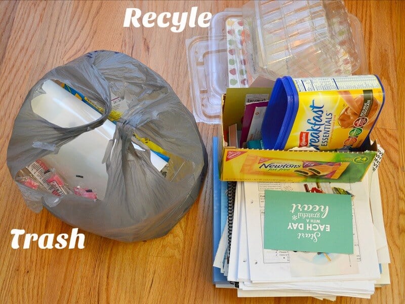 trash bag next to pile of recycling items with text reading Trash Recycle