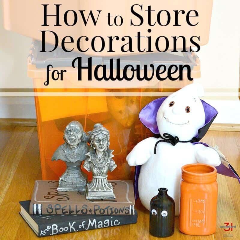Several different Halloween decorations sitting in front of orange and black storage tub with title text overlay reading How to Store Decorations for Halloween