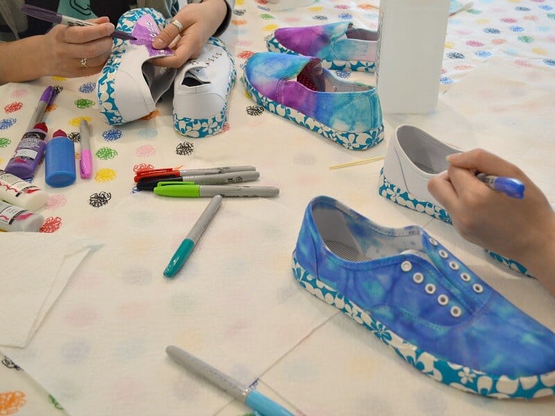 family activity coloring shoes with markers for tie dye