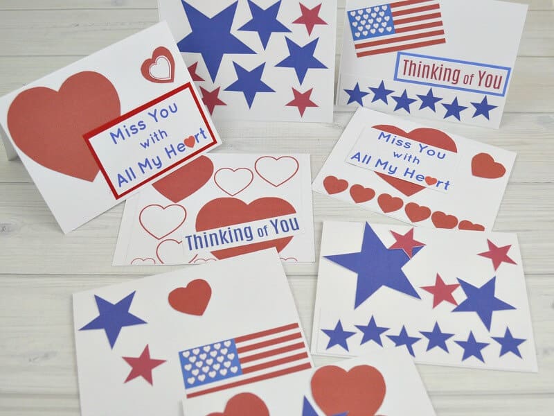 8 different DIY red, white and blue patriotic themed cards on white wood table