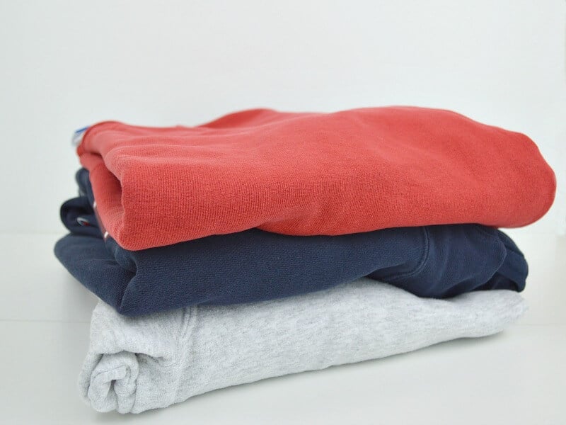 stack of 3 neatly folded sweatshirts 