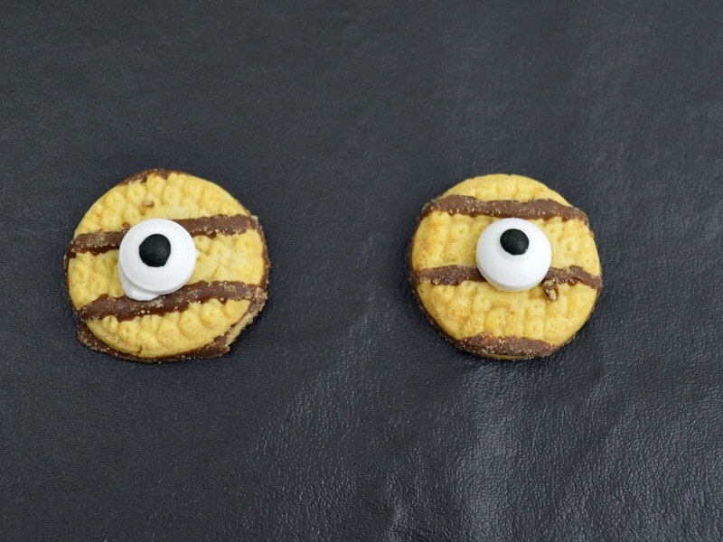 2 cookies with candy eyes attached