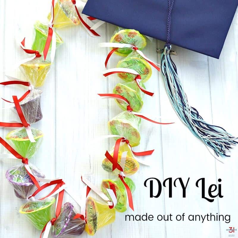 candy lei with red and white ribbon and blue mortar board with text overlay.