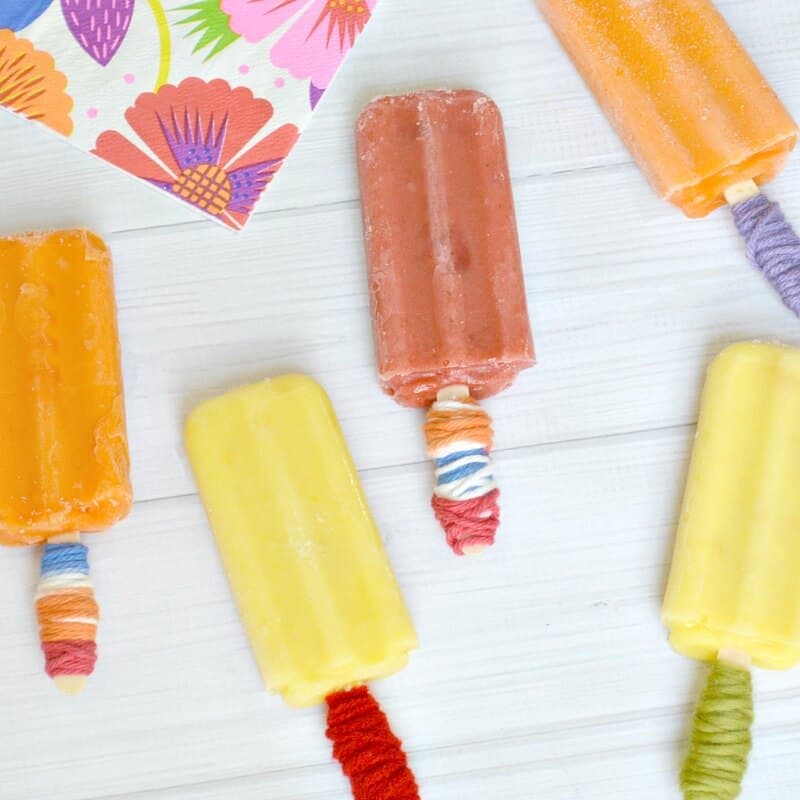 Overhead view of 5 popsicles lined up with holders