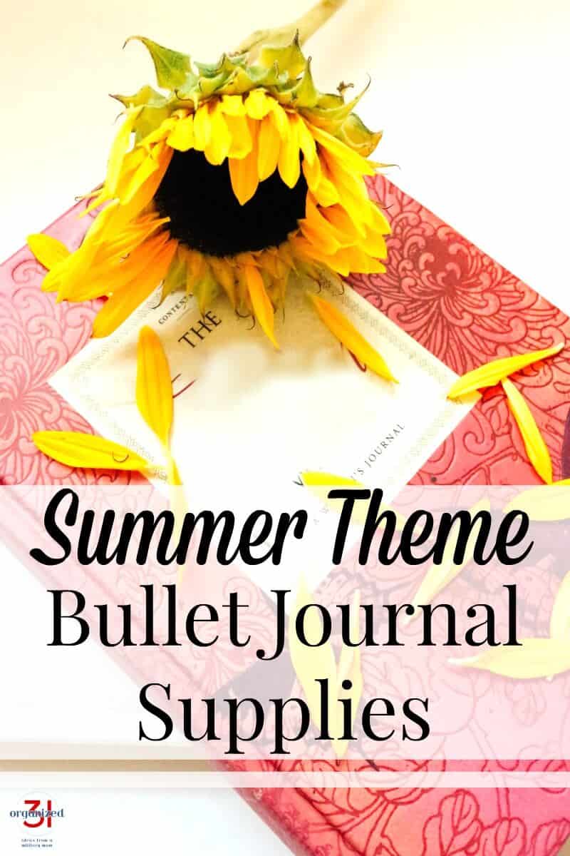 sunflower on top of pink journal with white label and flower petals scattered around with title text overlay reading Summer Theme Bullet Journal Supplies
