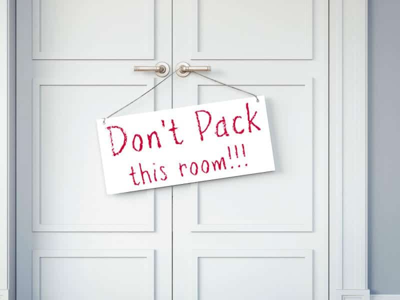 Closed white doors with "don't pack this room" sign in red