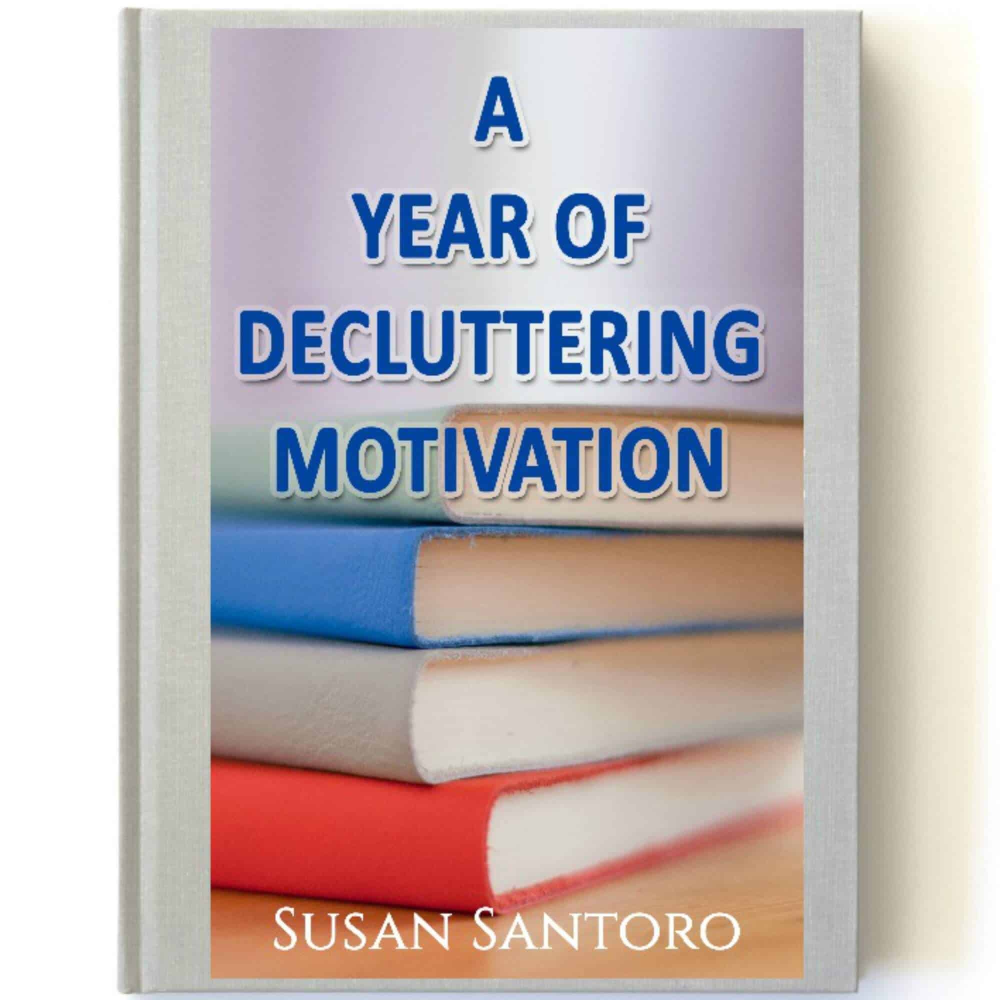 cover of book with image of stack of books with bright covers with text overlay reading A Year Of Decluttering Motivation