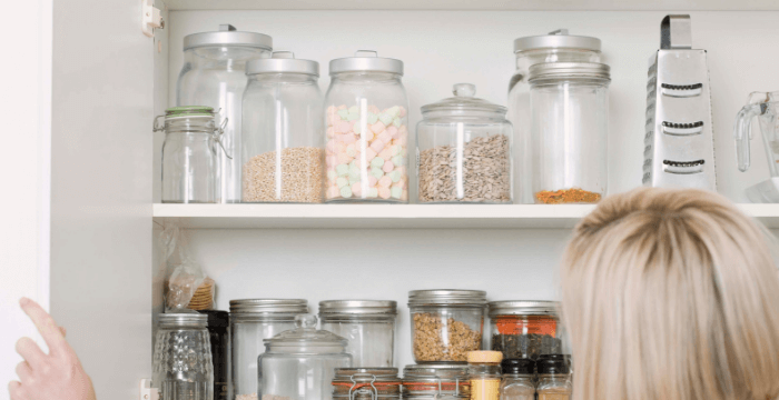 How to make your own kitchen pantry labels with no expensive purchases. 7 methods provide you with lots of options that organize beautifully. - Glass jars in kitchen cabinet