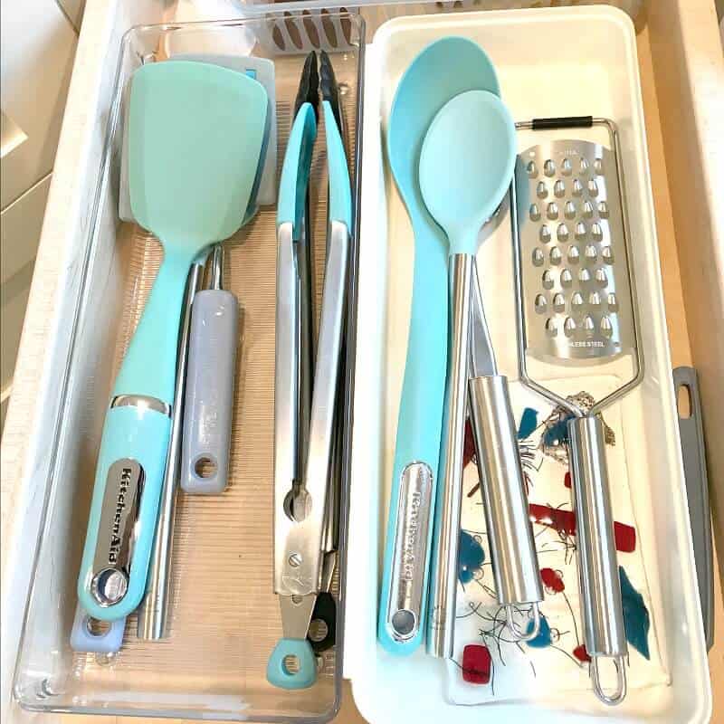 Turquoise kitchen utensils organized in drawer
