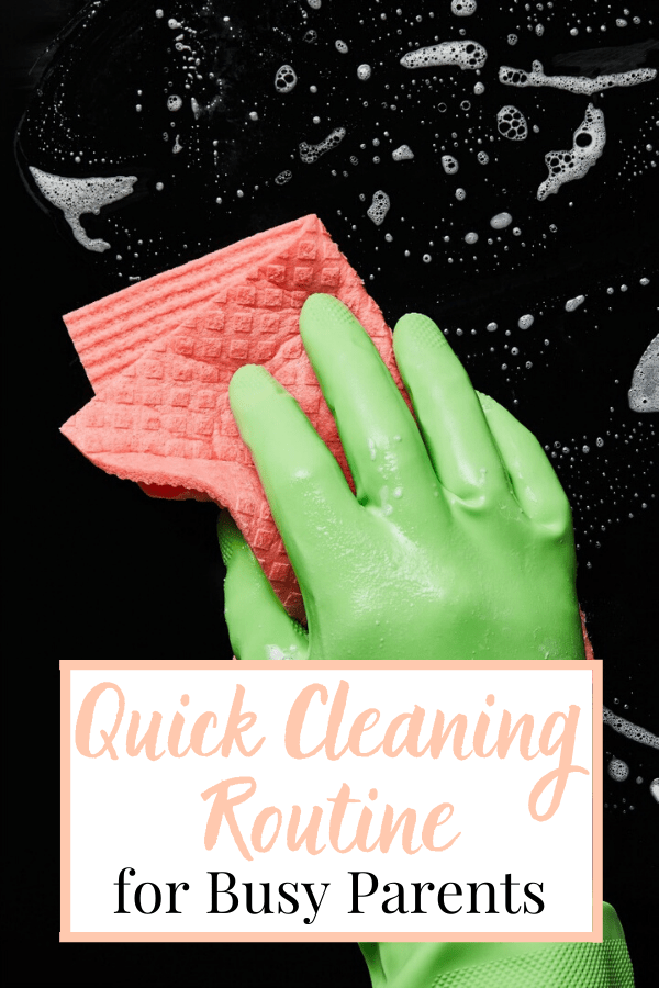 Green gloved hand holding orange sponge cleaning black surface with cleaning bubbles and text overla.y reading Quick Daily Cleaning Routine for Busy Parents