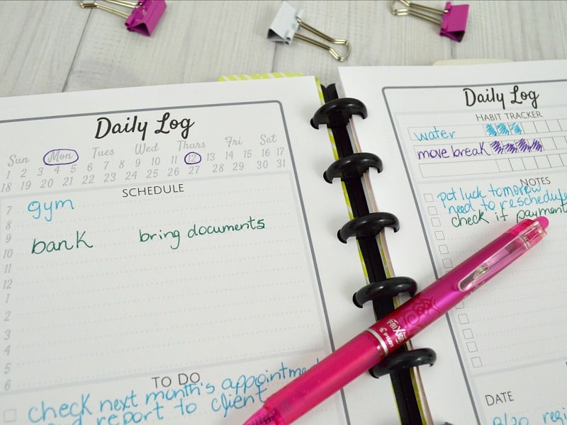 Close up of Daily Spread with pink pen and pink and white paper clamps