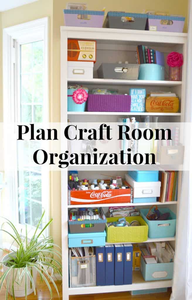 neatly organized white bookcase with craft supplies
