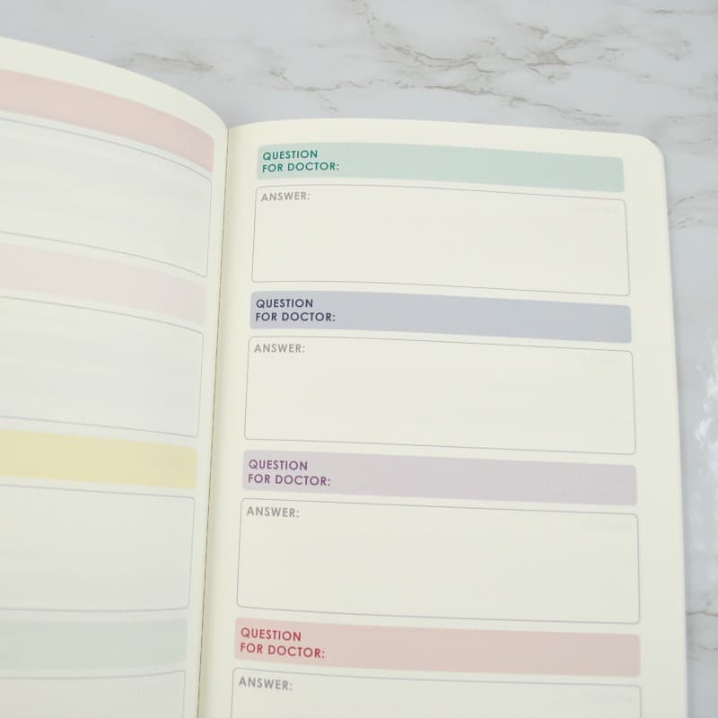 open notebook with writing areas with pastel headings.