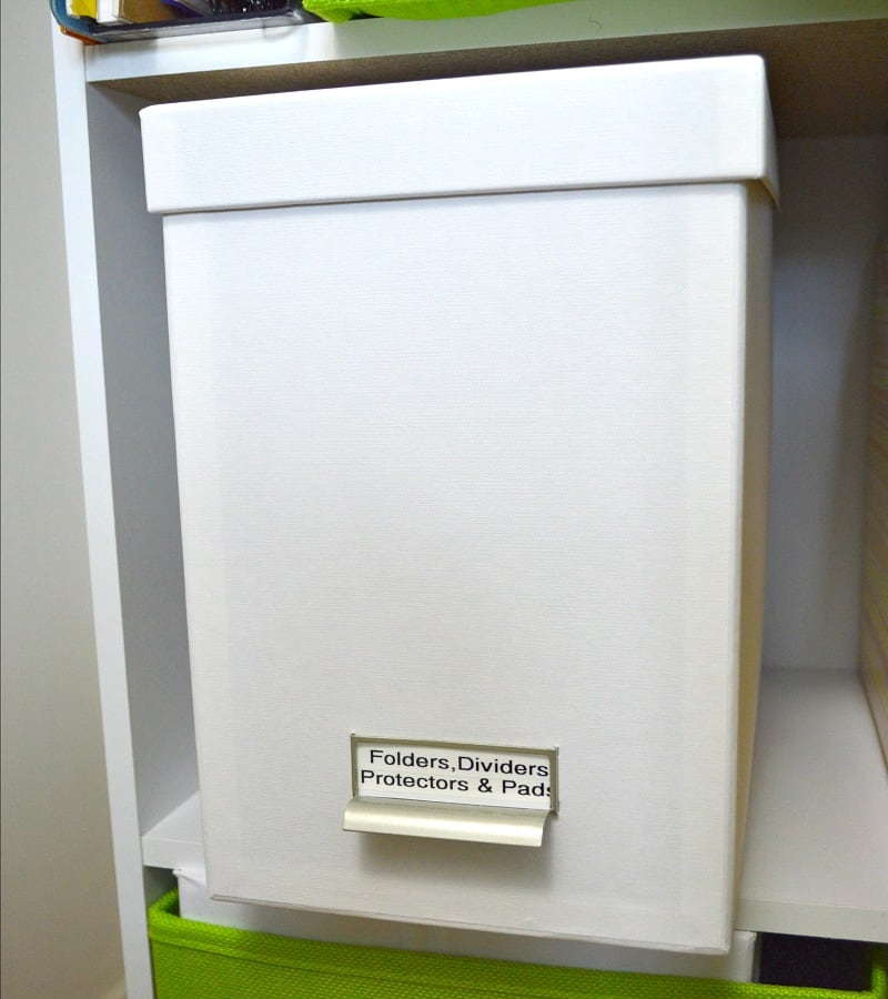 white document box on shelf with label "folders, dividers, protectors & pads"