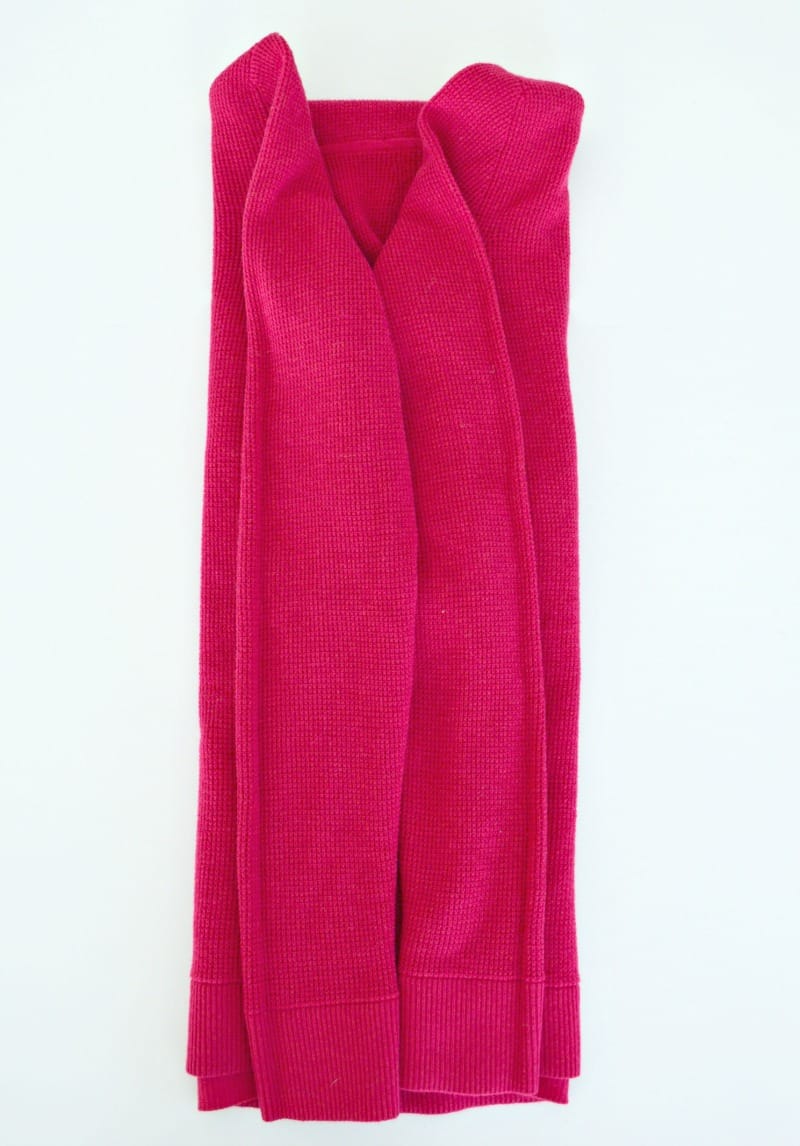 Pink hoodie with both sides and sleeves folded neatly into the middle of the hoodie.