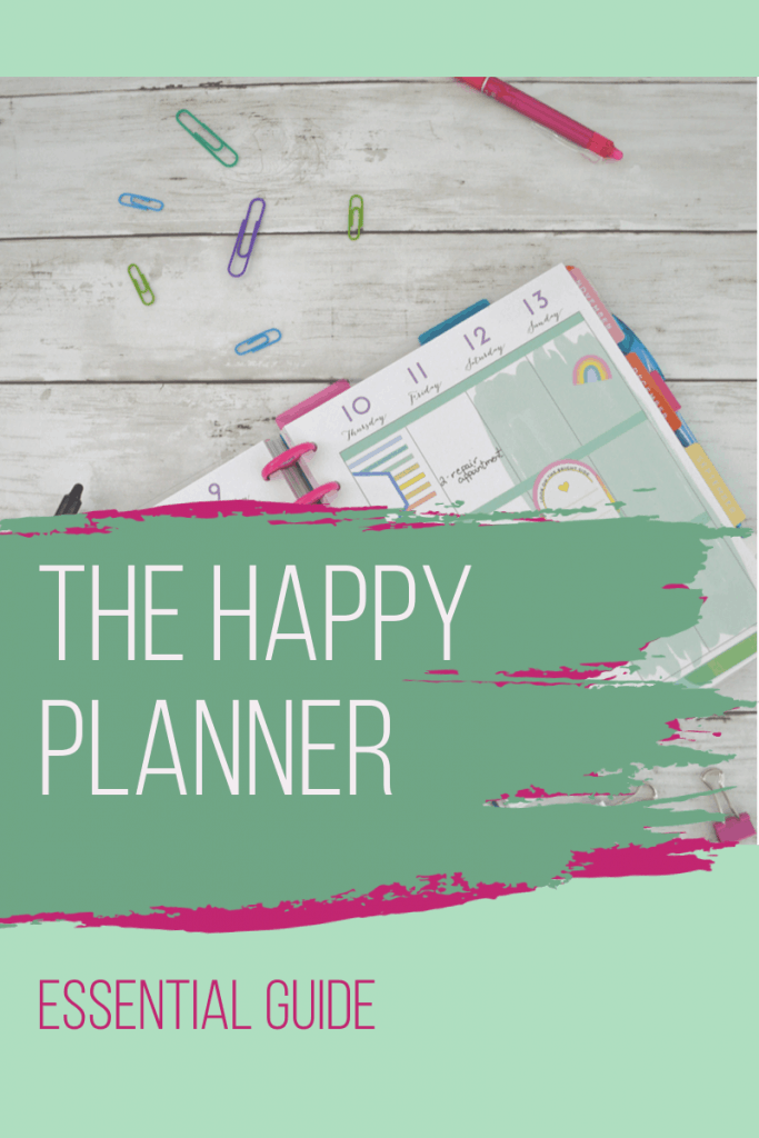 happy planner calendar with paper clips and pens and pink and green paint overlays