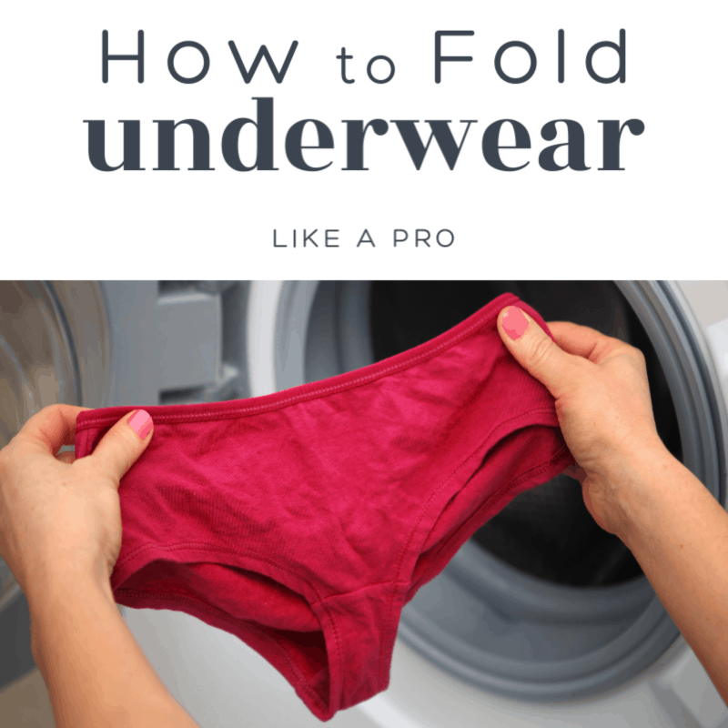 woman's hands holding up underwear in front of open clothes dryer