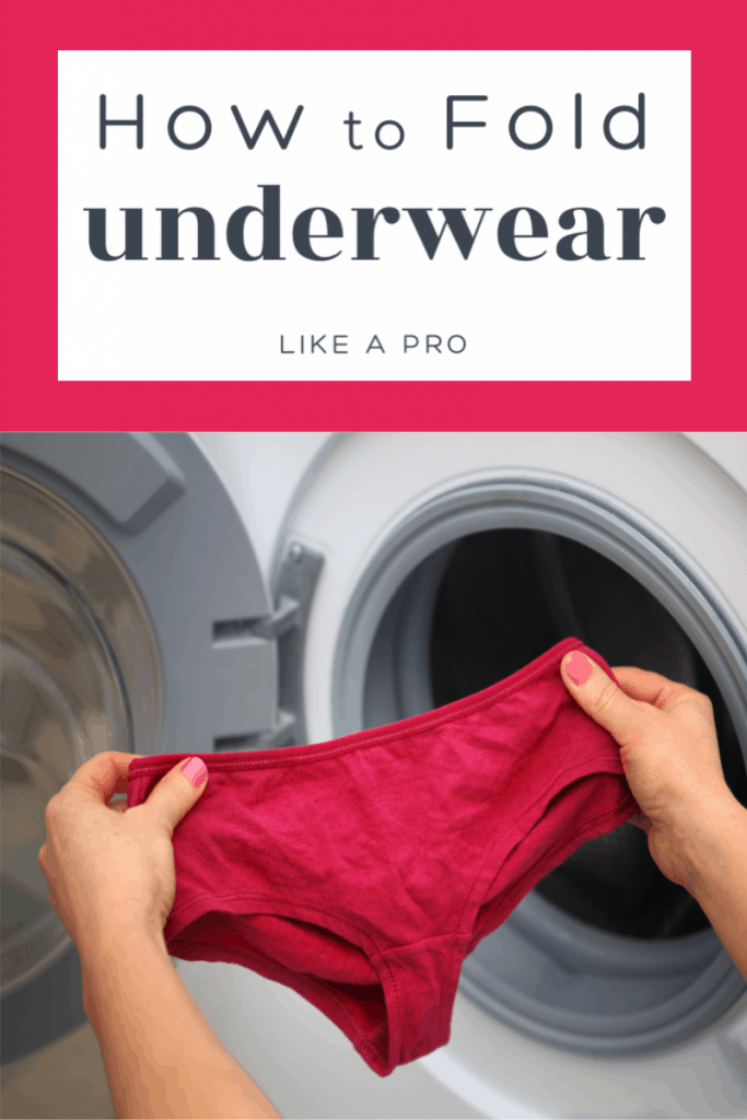 women's hands holding pink underwear in front open clothes dryer