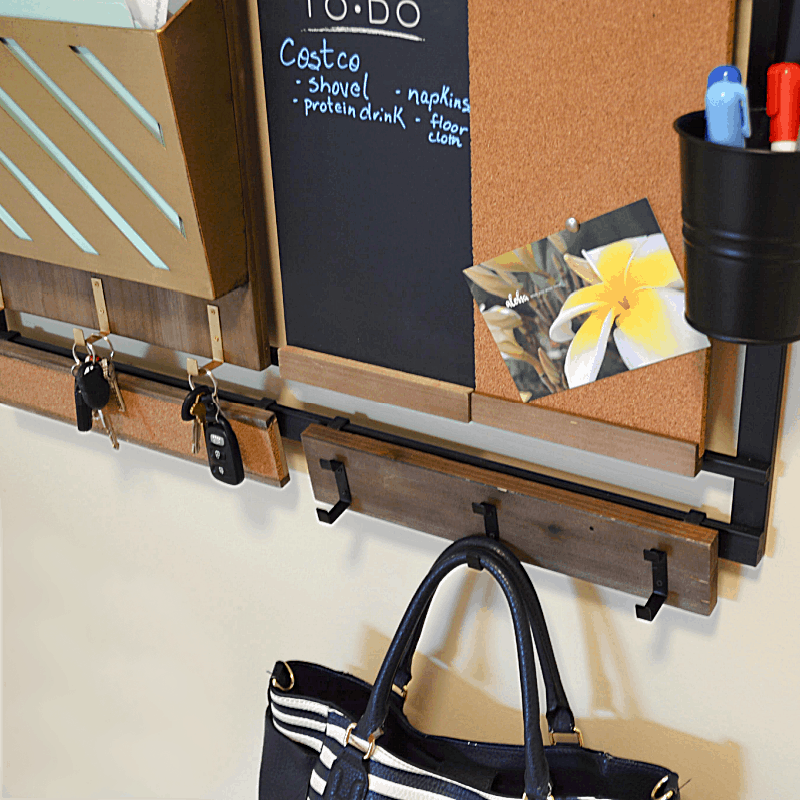 purse hanging on hooks of wall command center