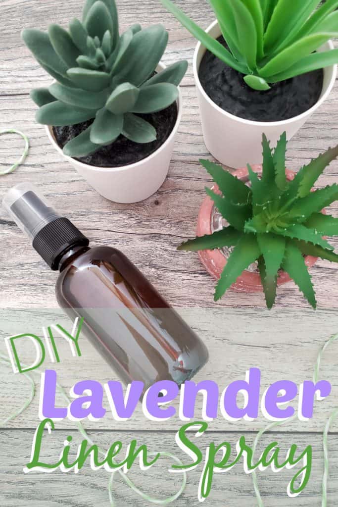 overhead view of small brown spray bottle on wood table next to 3 small green plants with green twine with title text reading DIY Lavender Linen Spray
