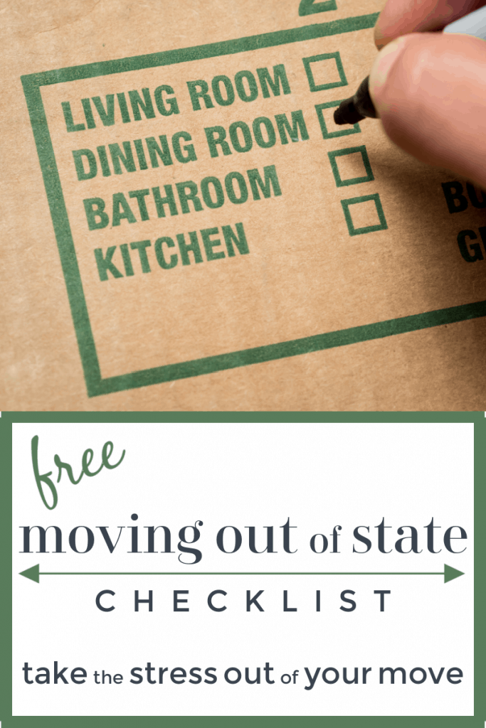 moving box with green writing and hand checking off box