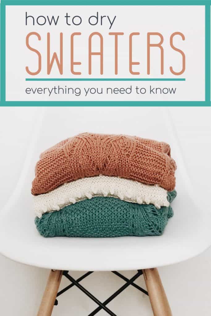 stack of 3 folded sweaters on white modern chair with text reading How to Dry Sweaters.