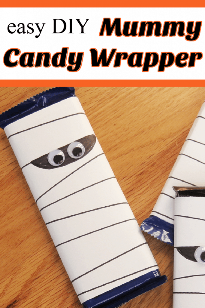 mummy wrappers with googly eyes on candy bars on wood table