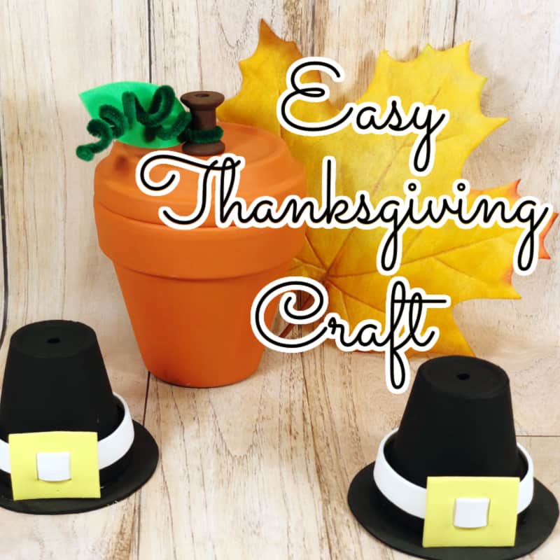 crafted clay pot pumpkin with 2 crafted pilgrim hats in front