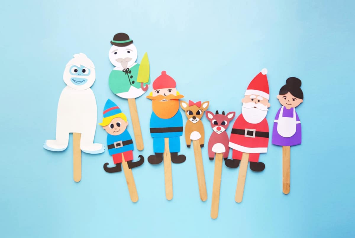 8 colorful paper Christmas puppets on popsicle sticks