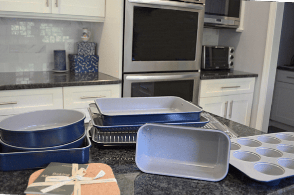 navy blue 11 piece bakeware set on black kitchen counter