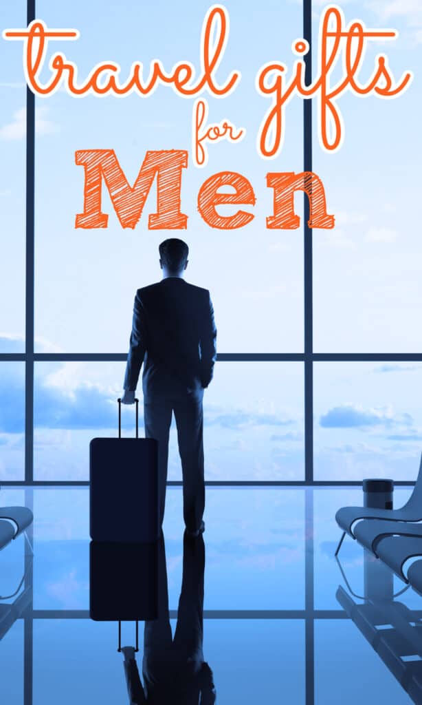 man in suit with suitcase looking out airport window