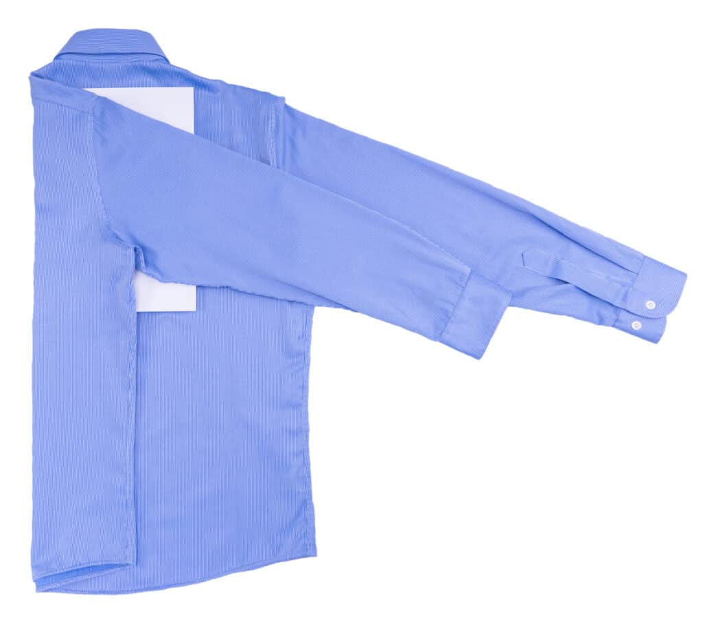 blue dress shirt with one sleeve folded over.