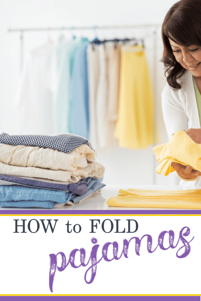 smiling woman folding yellow clothes next to neatly folded pile of clothes.