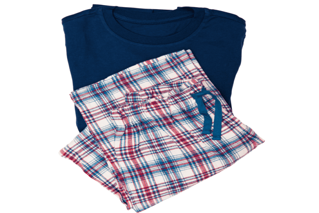 blue and red plaid pajama pants folded next to navy blue top.