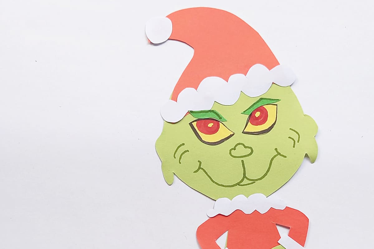 close up of face of paper Grinch puppet.