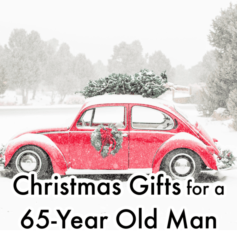 A red vintage car with a Christmas wreath on the door and a tree on the roof, set in a snowy landscape. Text overlay reads "Christmas Gifts for a 65-Year Old Man.